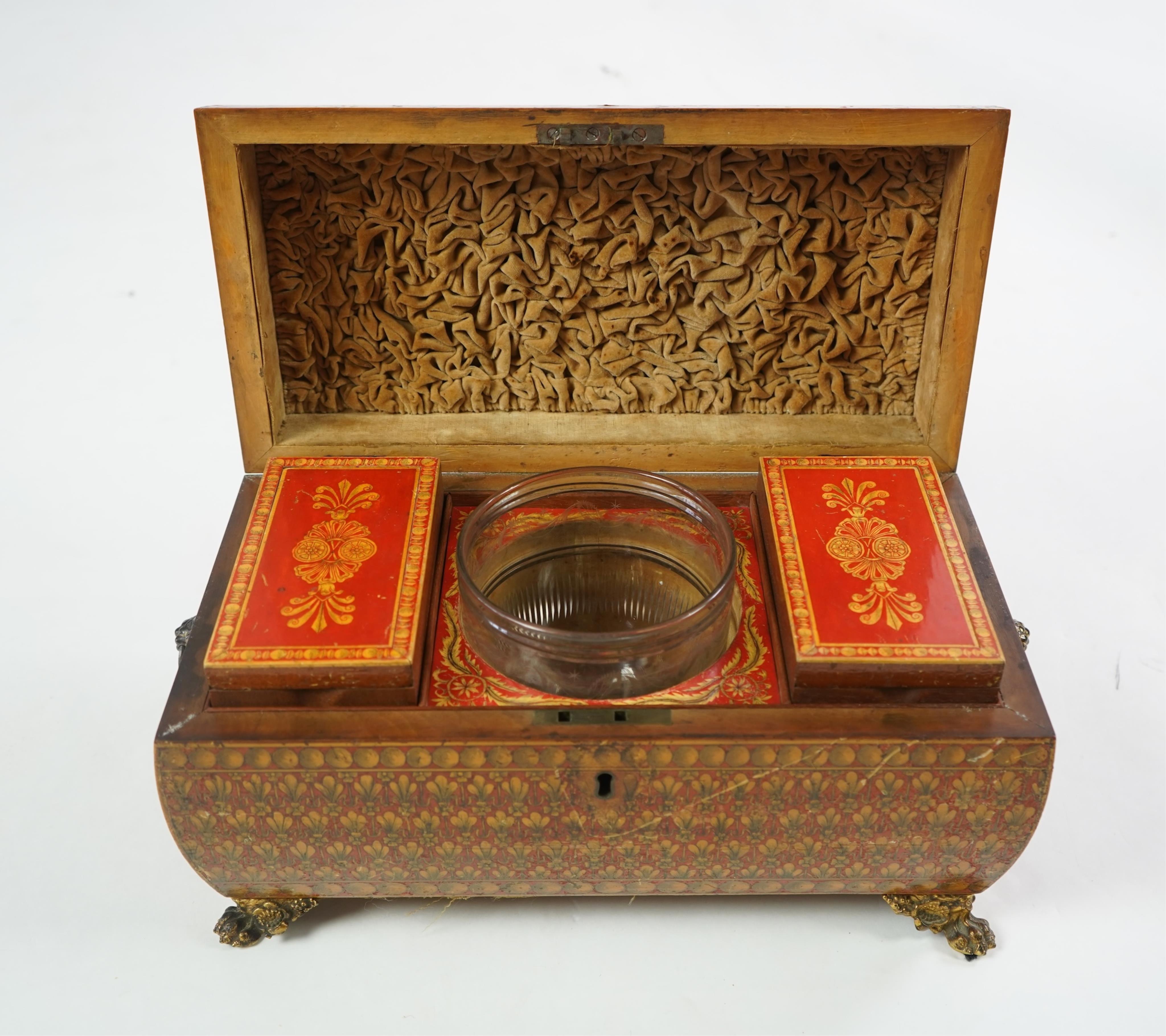 A Regency red lacquer penwork tea caddy